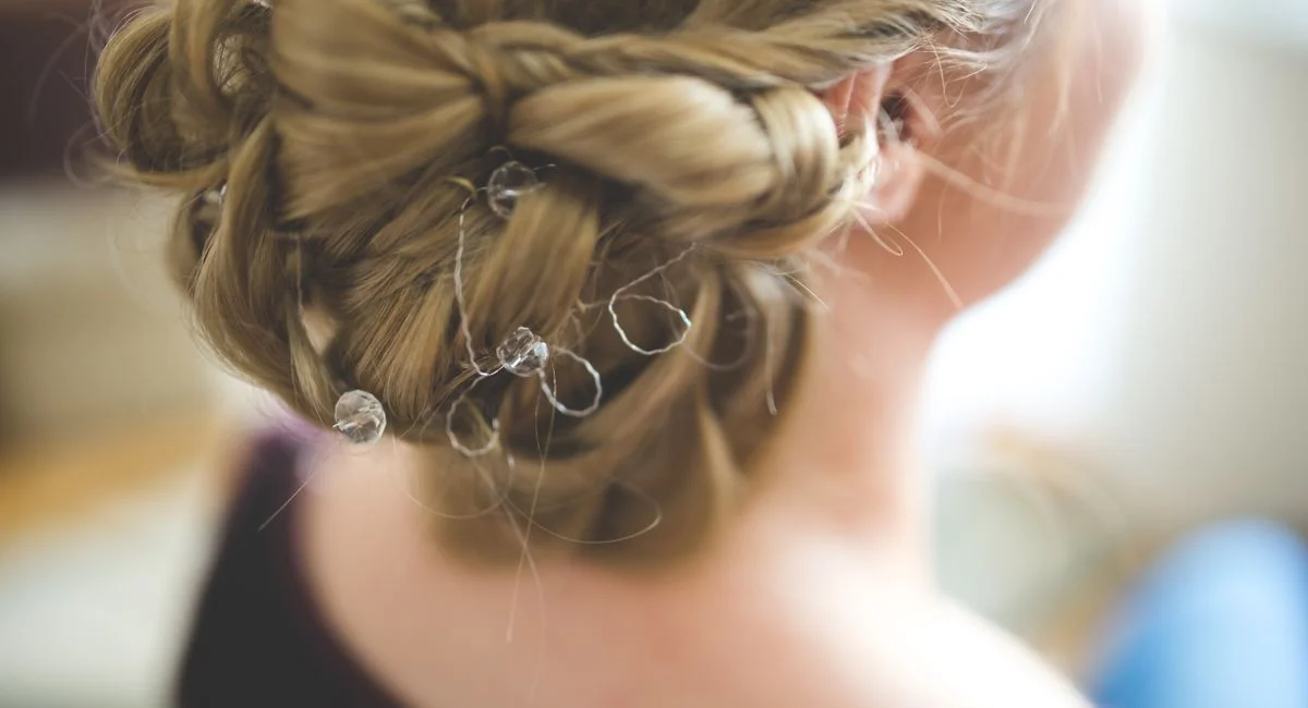 Close-up of an elaborate bridal hairstyle decorated with delicate crystals, perfect for wedding day inspiration.